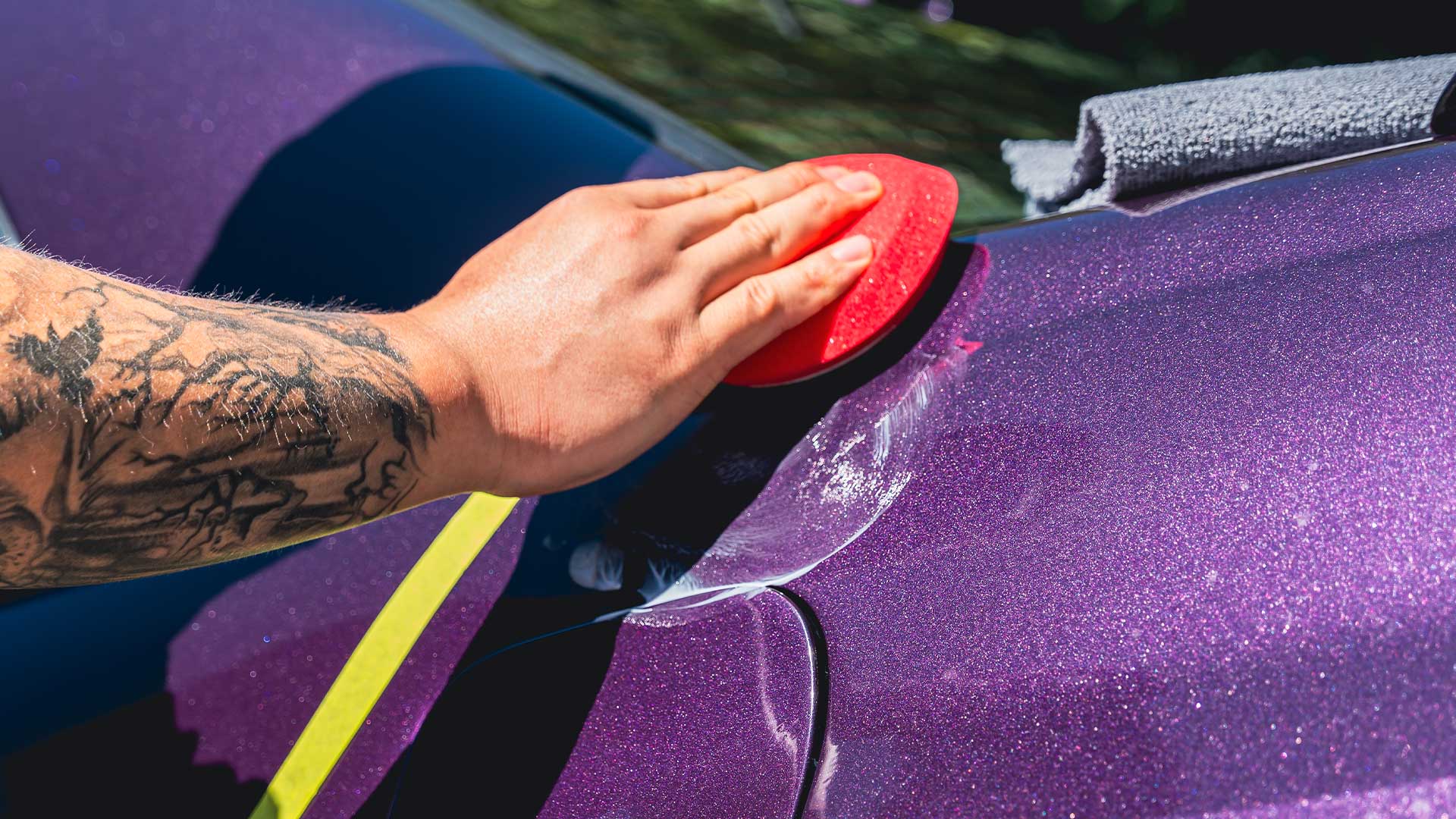 Purple vehicle receiving paint sealant treatment